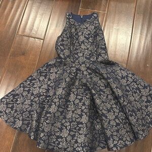Girls dress by Un Deux Trois. Size 7. Navy blue with silver flower pattern.